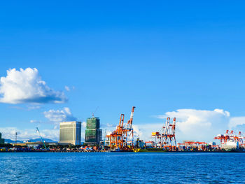 Commercial dock by sea against sky