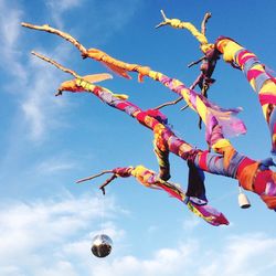 Low angle view of lanterns hanging against sky