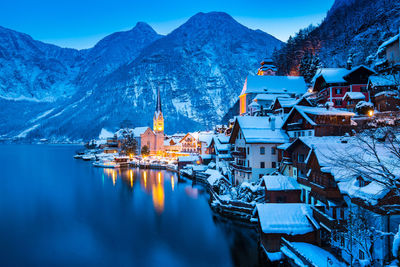 Snow covered townscape against sky