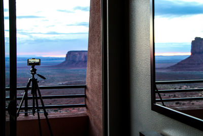 Close-up of camera seen through window