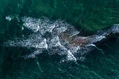 High angle view of water splashing on rocks