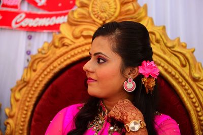 Smiling young bride looking away during wedding ceremony