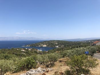 High angle view of sea and trees against sky