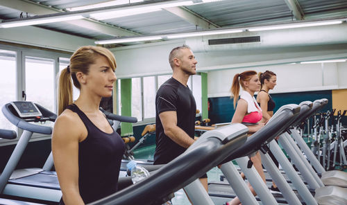 People walking on treadmills in gym