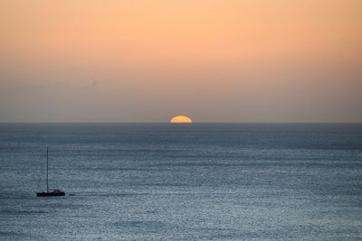 Scenic view of sea against clear sky during sunset