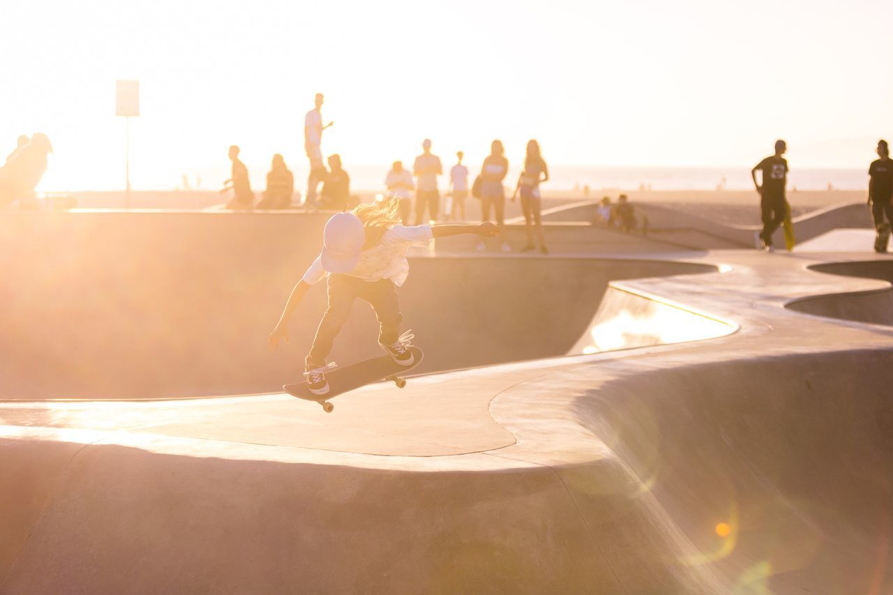 leisure activity, sunlight, skateboard park, real people, sport, skill, men, nature, lifestyles, group of people, skateboard, full length, day, people, enjoyment, sports ramp, shadow, sports equipment, stunt, outdoors, lens flare