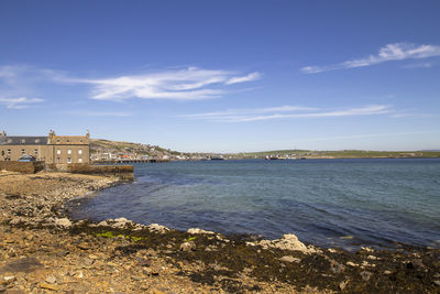 Scenic view of sea against buildings in city