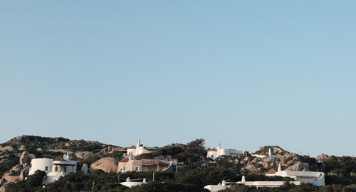 Houses in town against clear sky