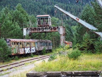 Abandoned train on railroad track in forest