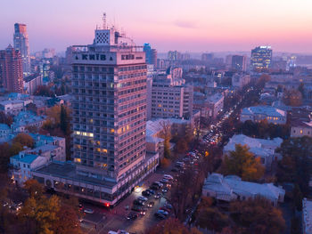 High angle view of illuminated buildings against sky at dusk