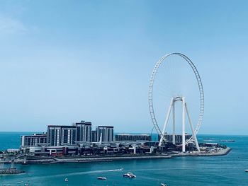 Ferris wheel in city at waterfront