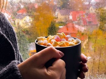 Close-up of hand holding ice cream