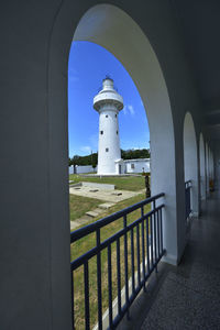 Lighthouse against sky seen through archway