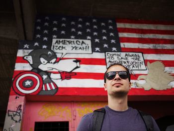 Low angle view of man standing against building