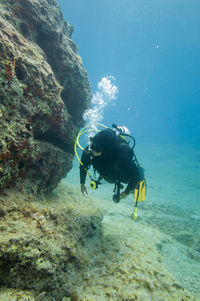 Woman scuba diving in sea