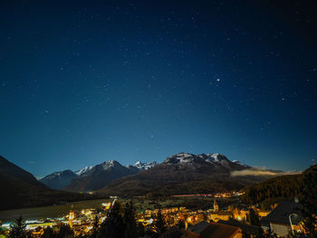 Scenic view of illuminated mountains against sky at night