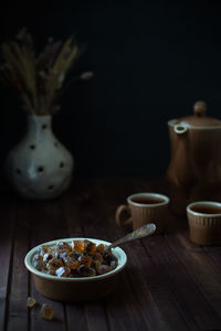 Canded sugar in dark key. dark moody lollipop sugar still-life with tea set. vertical format