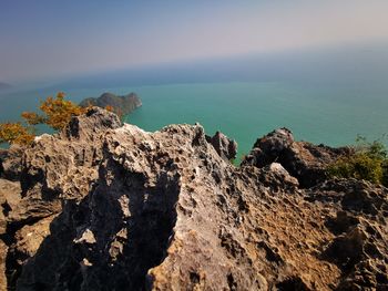 Rock formation on beach against sky