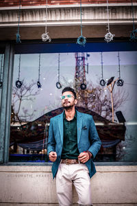 Portrait of young man wearing sunglasses standing outdoors