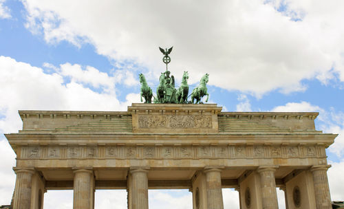 Low angle view of statue against cloudy sky.   berlin