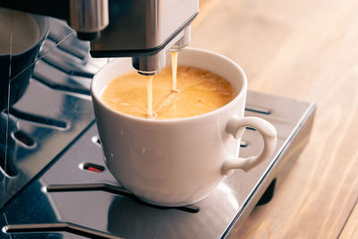 Espresso coffee preparation on a wooden table