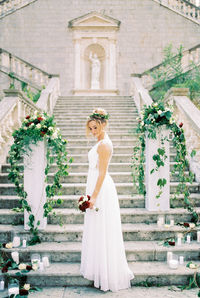 Portrait of bride standing against building