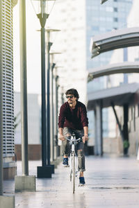 Man riding bicycle on city