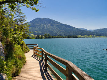 Scenic view of lake and mountains against sky