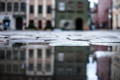 Reflection of building in puddle