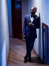 Portrait of businessman standing in corridor