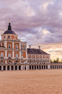 Exterior of historic building against sky during sunset