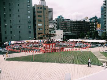 People in city against sky