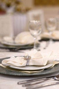 Close-up of napkin on plate at dining table