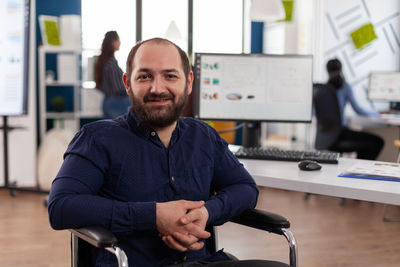 Portrait of young man sitting in office