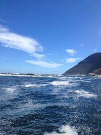 Scenic view of sea against blue sky