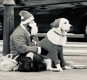 Man with dog sitting outdoors