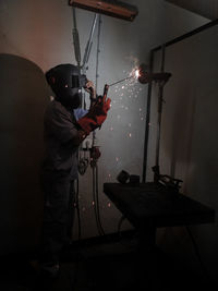 Side view of boy holding umbrella