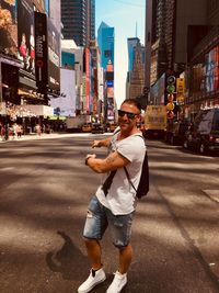 Portrait of man gesturing while standing on city street