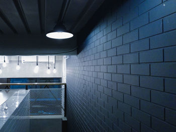 Illuminated lights on tiled wall