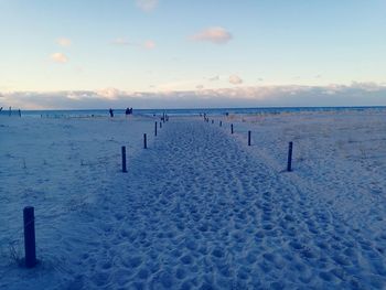 Scenic view of beach against sky during winter