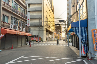 Road by buildings in city