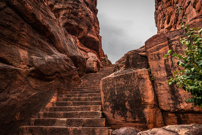 Low angle view of steps amidst rock formation