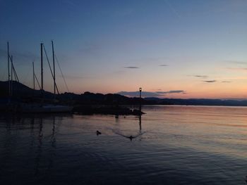 Boat in sea at sunset