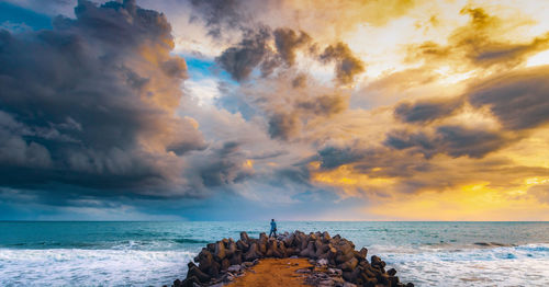 A dramatic sunset by the shore.