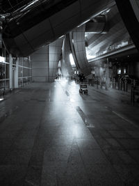 Illuminated street amidst buildings in city at night