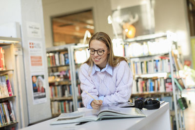 Young woman studying in library