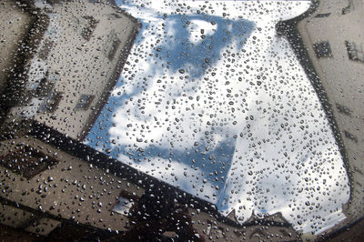 High angle view of raindrops on glass window