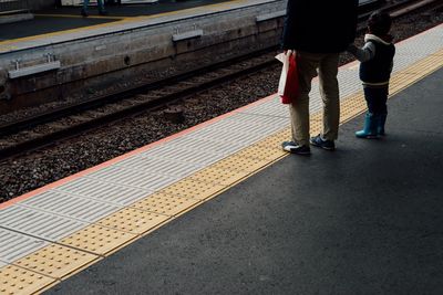 Low section of people on railroad station platform