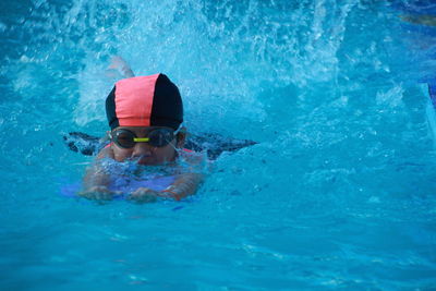 Boy swimming in pool