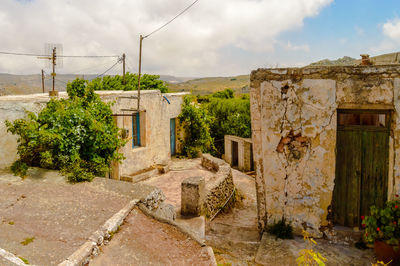 Old building by street against sky